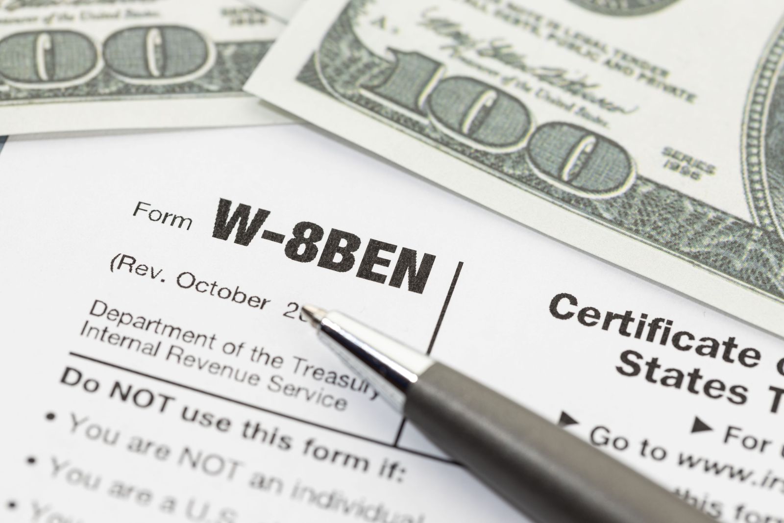 Form W-8BEN with a pen